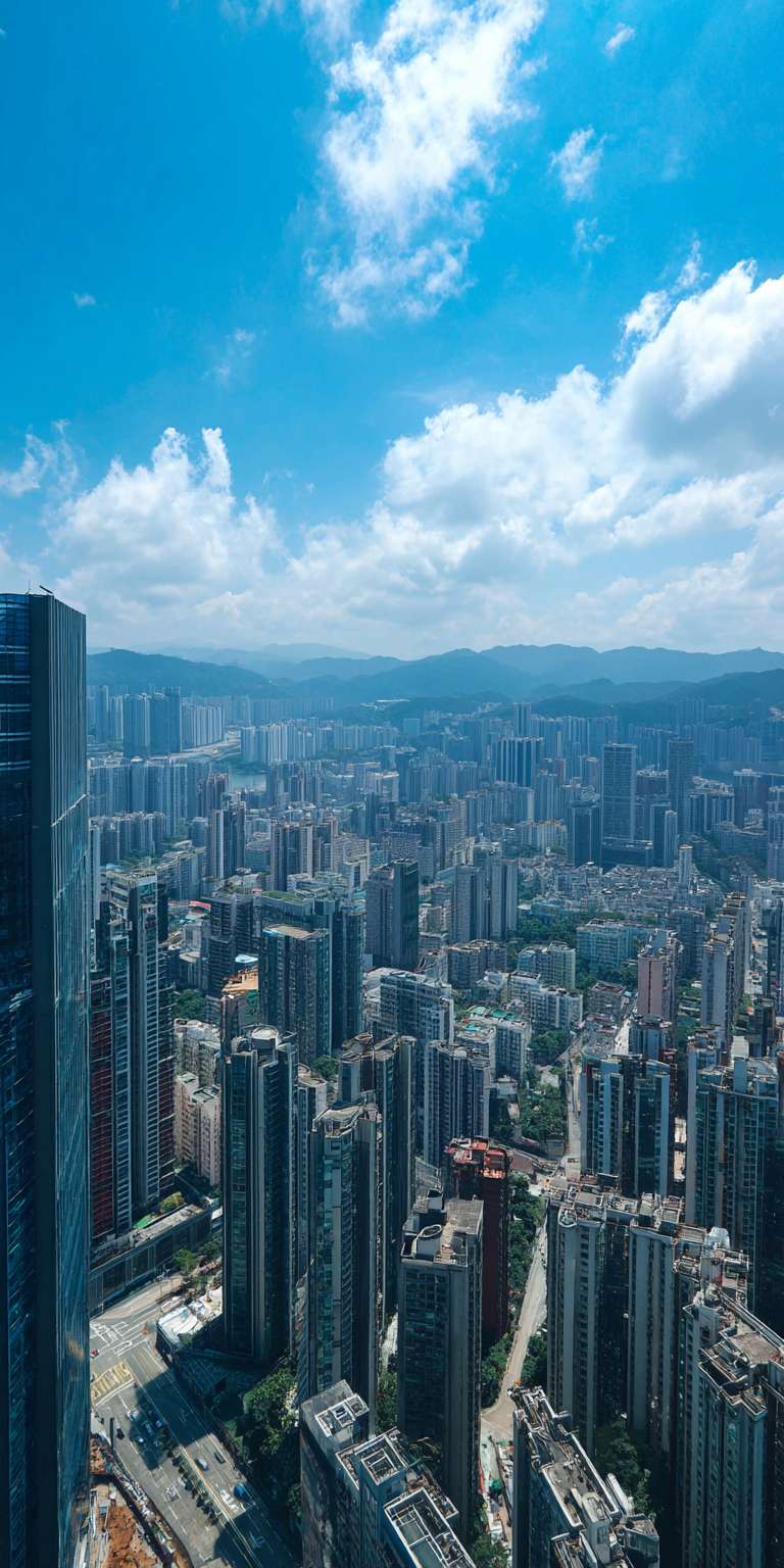 从高处俯瞰现代化大都市，众多摩天大楼林立，玻璃幕墙在阳光下熠熠生辉，城市街道穿插其间，上方是晴朗的蓝天和少量白云，氛围开阔且充满现代感。 --ar 1:2 --v 7 --stylize 100 --fast --no 水印