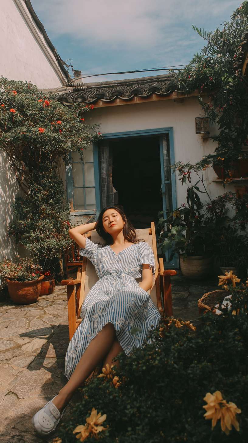 在一个白墙灰瓦的大理小院子里，一个美女在躺椅上悠闲的躺着晒太阳，院子里开满了花 --ar 9:16 --v 7 --stylize 100 --fast --no 水印